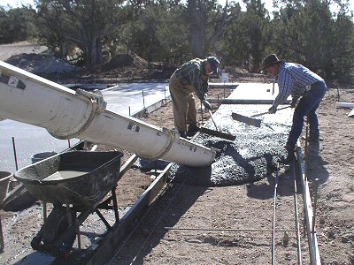 Photo of a crew poring concrete for a manufactured home